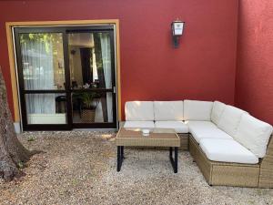 a white couch and a table in front of a building at Hotel Augsburg Langemarck in Augsburg