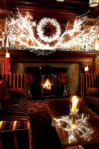 a living room with a fireplace with christmas lights at Netherwood Hotel & Spa in Grange Over Sands