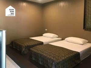 Кровать или кровати в номере Suan Rom Mai Chanthaburi สวนร่มไม้ จันทบุรี