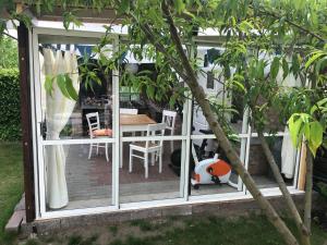 a screened in porch with a table and chairs at Apartamenty i Pokoje Na Letniej in Darłowo