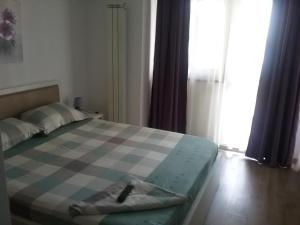 a bedroom with a bed with a platter on it at Flory`s Apartment Mamaia in Mamaia