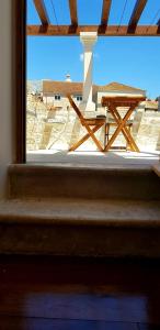 a window with a table and a picnic table on a patio at The Fabris - Luxury Inn in Korčula