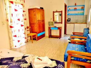 a living room with a table and a kitchen at Studios Elina in Skala Potamias