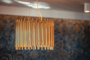 a bunch of yellow sticks hanging from a ceiling at Nautilus Hotel in Giardini Naxos