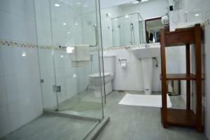 
a bathroom with a toilet, sink, and shower stall at Colombo Villa at Cambridge Place in Colombo
