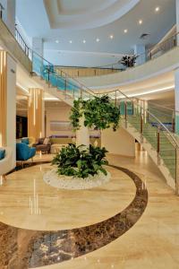 a lobby with a spiral staircase and a plant at MiRaBelle Hotel - Half Board Plus & All Inclusive in Golden Sands