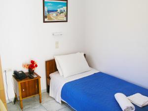 A bed or beds in a room at Hotel Helena