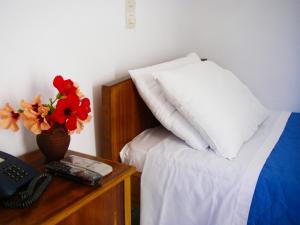 A bed or beds in a room at Hotel Helena