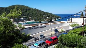 a parking lot with cars parked in front of a building at Best4You Apartment - sea view - 70 m2 - 2 bedrooms in Dubrovnik