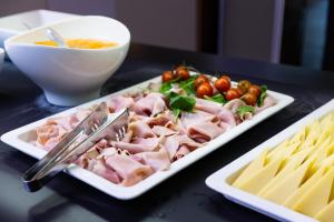 a plate of food with meat and vegetables on a table at Hotel Pinija in Petrcane