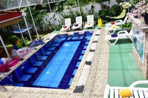 a swimming pool with chairs and a swimming pool at Colombo Villa in Colombo