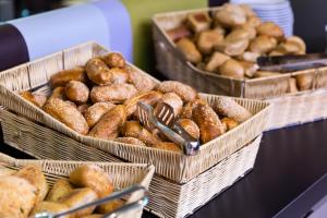 three baskets of donuts sitting on a table at Hotel Pinija in Petrcane