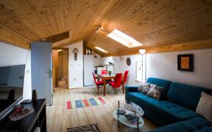 a living room with a blue couch and a table at Holiday Homes Mirjana in Mošćenička Draga