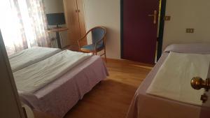 Postel nebo postele na pokoji v ubytování Hotel Rialto