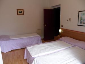Postel nebo postele na pokoji v ubytování Hotel Rialto