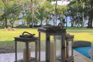 two lanterns sitting on a table in a park at Amazing ocean views with many extras perks to enjoy in Cabarete