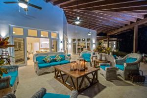 a patio with blue furniture and a table at Amazing ocean views with many extras perks to enjoy in Cabarete