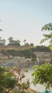 a group of people on a beach near a river at The Blue Mile in Paralimni +11 photos