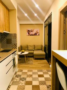 a living room with a couch and a table at North Avenue Loft Apartments in Yerevan +9 photos