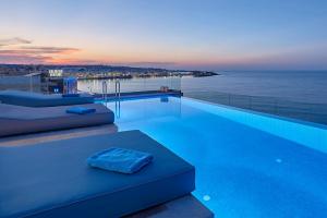 a swimming pool with a view of the ocean at Seafront Apartments by Myseasight in Hersonissos