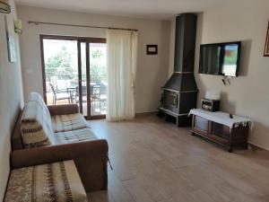 a living room with a couch and a stove at Casa Emma in Krk