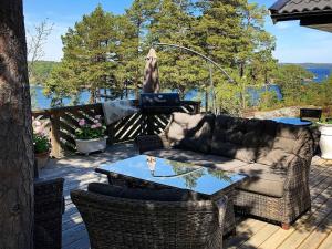 a patio with a couch and a table on a deck at Four-Bedroom Holiday home in Dalarö in Dalarö