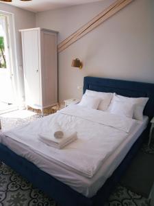 a bedroom with a large bed with a blue headboard at Dolce in Duszniki Zdrój