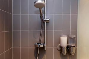 a shower stall with a light and a candle at Hotel Bethel in Copenhagen