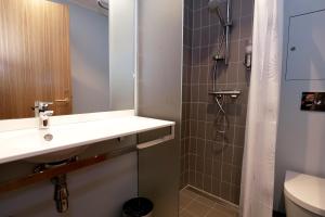 a bathroom with a sink and a shower at Hotel Bethel in Copenhagen