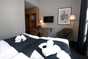 a hotel room with a bed with towels on it at Hotel Bethel in Copenhagen