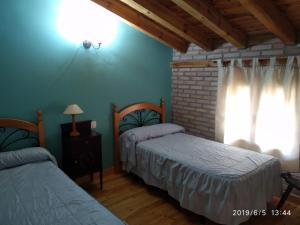 Łóżko lub łóżka w pokoju w obiekcie Hostal Camino Del Cid