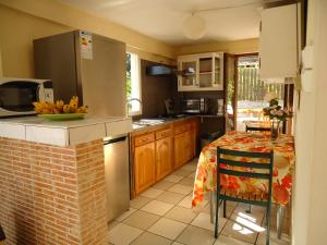 a kitchen with a table and a counter top at villa cocotiers in Sainte-Marie