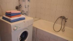 a bathroom with a washing machine and a bath tub at Vesna Apartments in Ulcinj