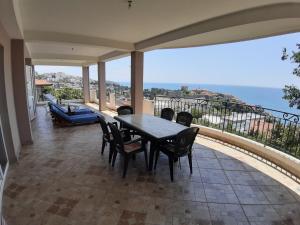 a dining room with a table and chairs on a balcony at Vesna Apartments in Ulcinj