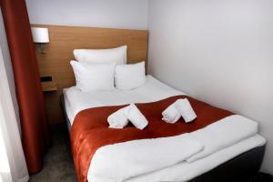 a hotel room with a bed with two pillows at Hotel Bethel in Copenhagen