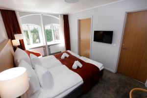 a hotel room with a bed and a window at Hotel Bethel in Copenhagen