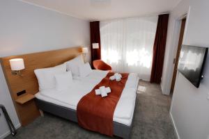 a hotel room with a bed with bows on it at Hotel Bethel in Copenhagen