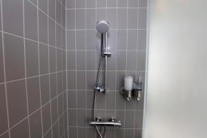 a shower with a shower head in a bathroom at Hotel Bethel in Copenhagen