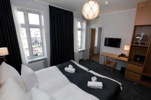 a hotel room with a bed with two towels on it at Hotel Bethel in Copenhagen