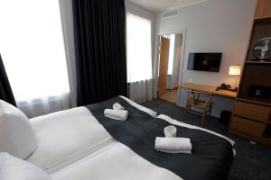 a hotel room with a bed with two pillows on it at Hotel Bethel in Copenhagen