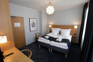 a hotel room with a bed and a table at Hotel Bethel in Copenhagen