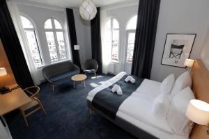 a hotel room with a bed and a chair at Hotel Bethel in Copenhagen