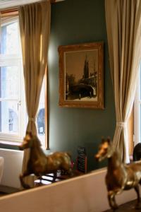 a living room filled with furniture next to a window at B&B Au Lion D'or in Maastricht