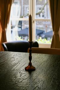 a wooden table with a candle on top of it at B&B Au Lion D'or in Maastricht