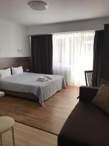 Postel nebo postele na pokoji v ubytování Neopolis