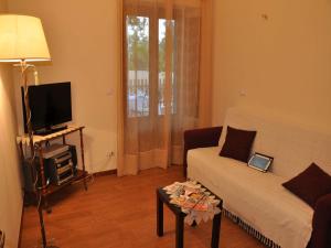 a living room with a couch and a tv at Villa Venere Sicily in Piedimonte Etneo