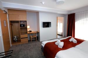 a hotel room with a bed and a desk at Hotel Bethel in Copenhagen