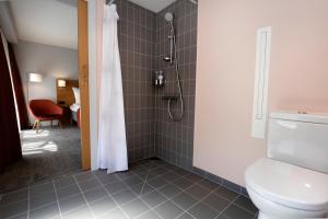 a bathroom with a shower and a toilet at Hotel Bethel in Copenhagen