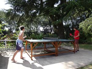 two people standing around a ping pong table at Westhill Country Hotel in Saint Helier Jersey