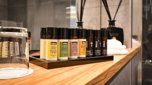 a row of bottles of oils sitting on a shelf at Hotel Olea in Novalja